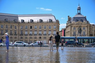 tourists enjoying place de la bourse water mirror