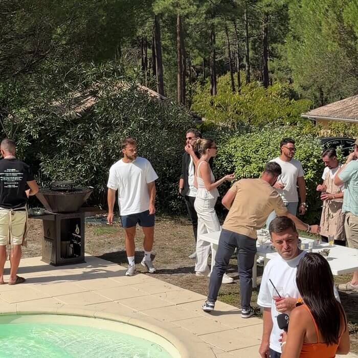 Groupe d'amis au bord d'une piscine autour d'un brasero en Gironde